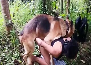 German Shepherd lets Latina lady do oral work on his shaft outdoors