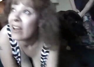 Big tits mature blonde wants to seduce black Labrador into zoo sex