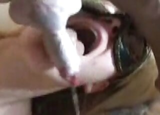 Masked blond-haired angel deepthroating a dog's dong happily