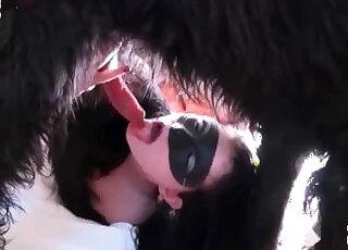 Attractive babe in a black mask is ready to suck on furry dicks too